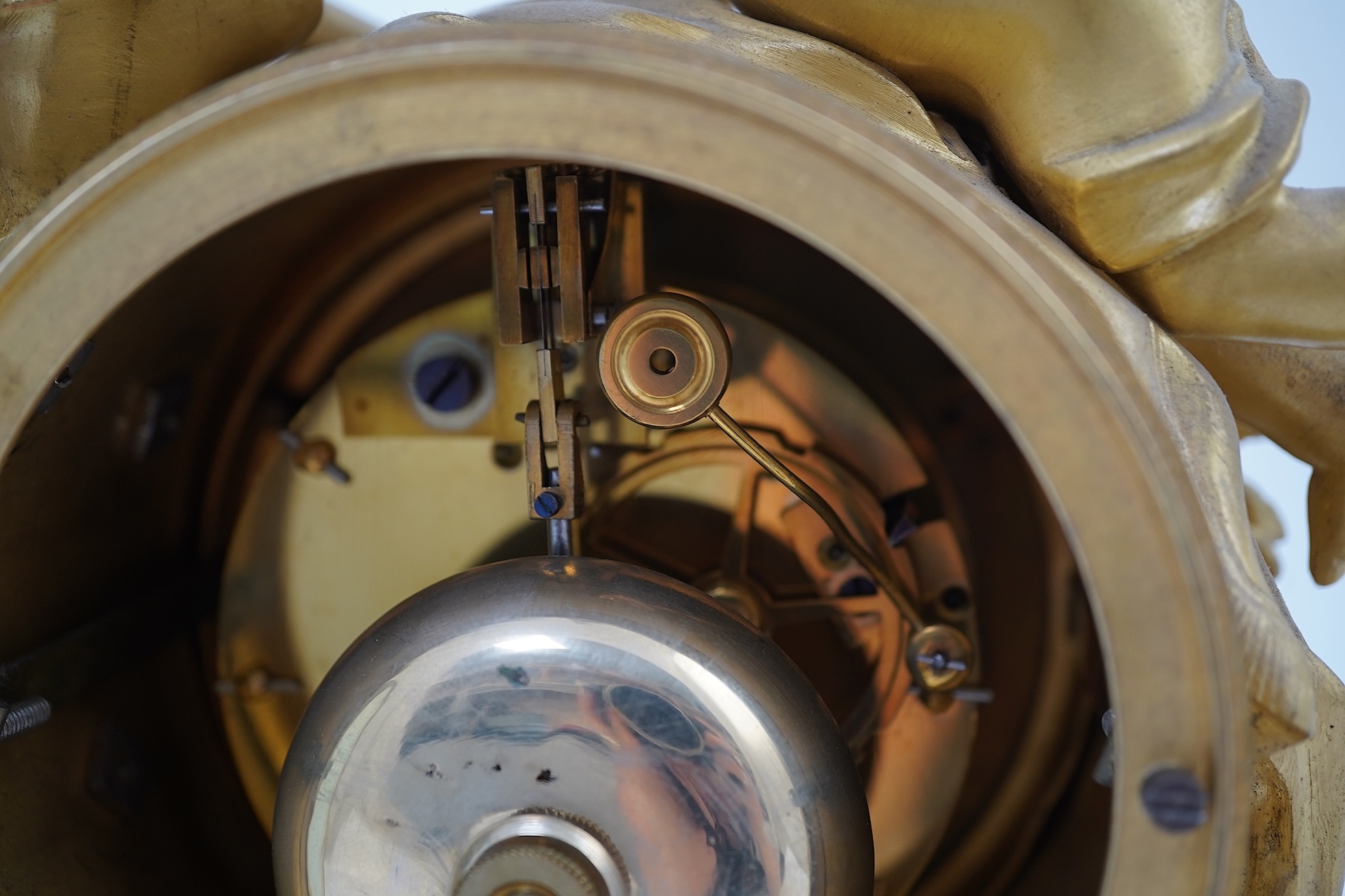 An early 19th century French figural ormolu and white marble mantel clock